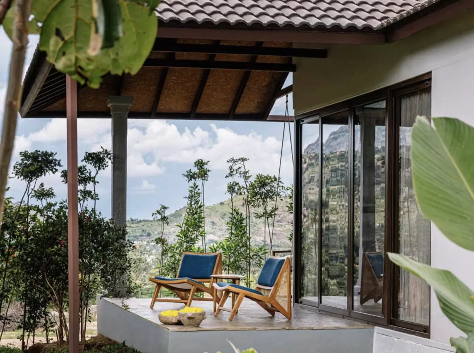 A private patio with chairs looking out over the hills