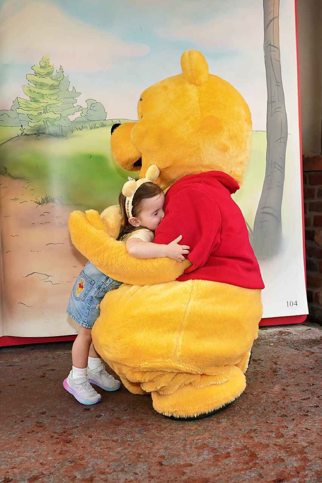 A toddler hugging Winnie the Pooh at Walt Disney World Resort