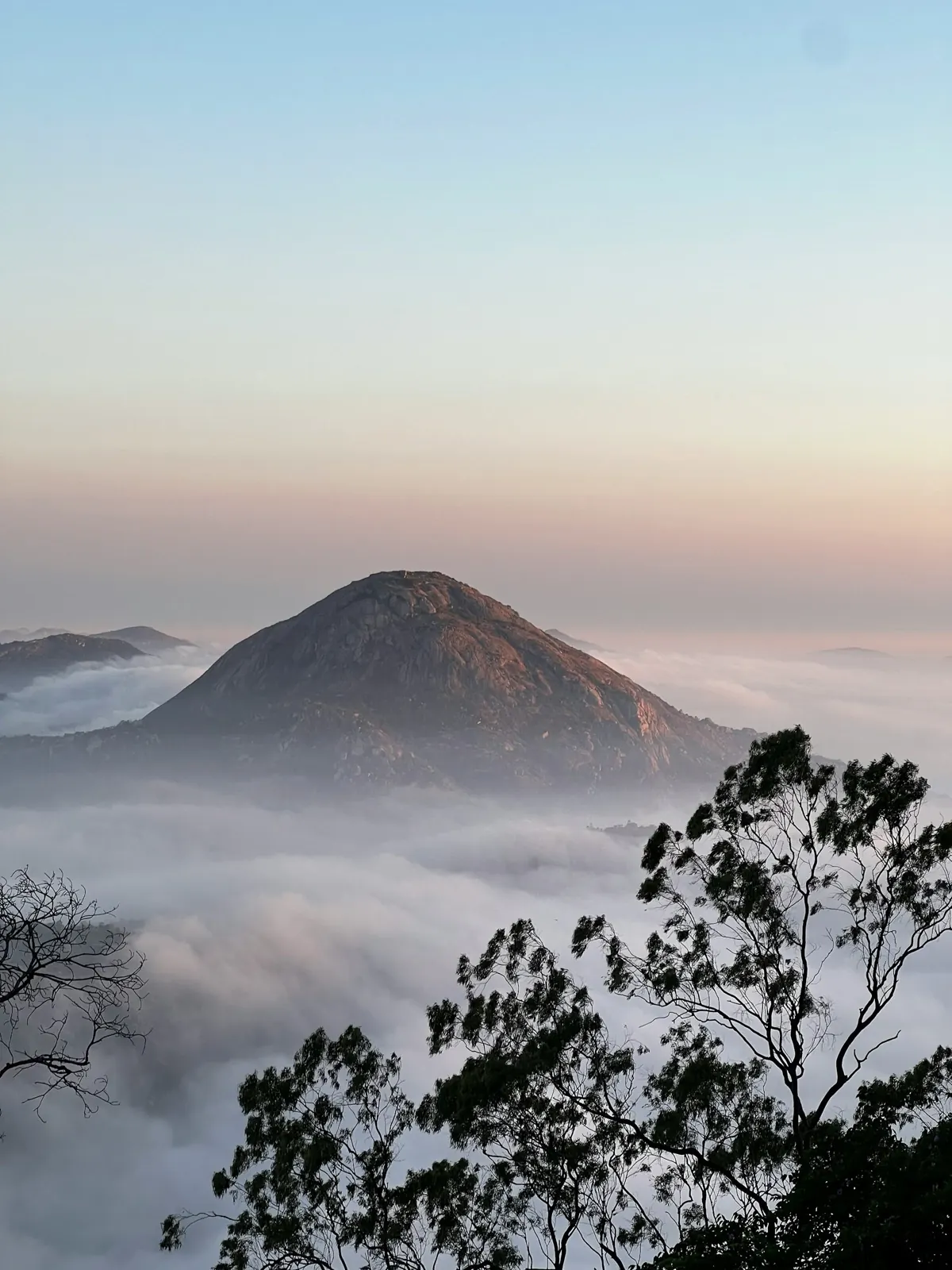 Sunrise over the Nandi Hills, with the valley below under cloud