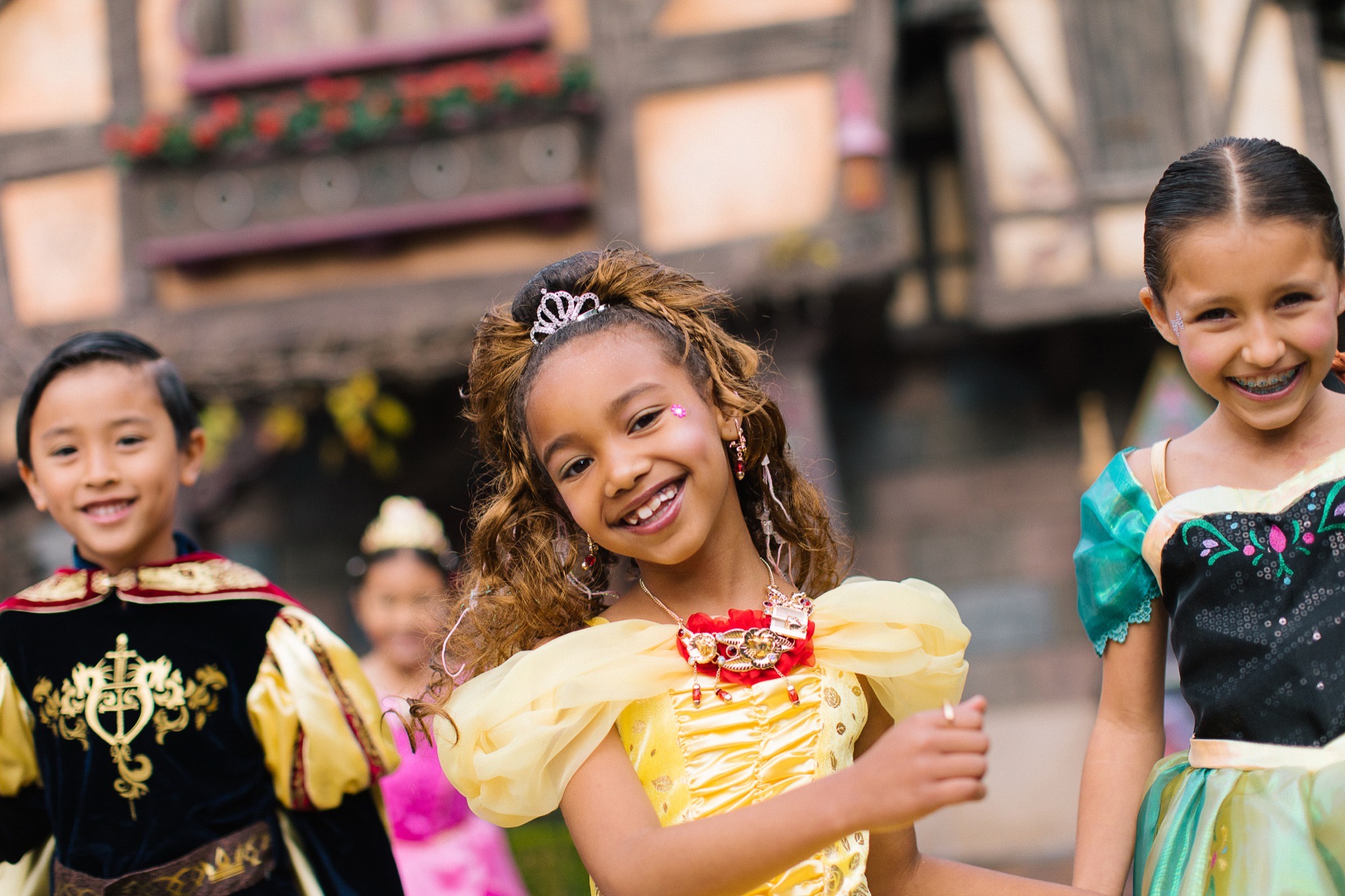 Three children in princess gowns and a knight costume after their boutique makeover